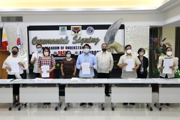 Department of Social Welfare and Development (DSWD) Secretary Rolando Joselito D. Bautista (middle), Philippine Association of Social Workers, Incorporated (PASWI) National President Raosauro Luntayao (2nd from right), and Association of Local Social Welfare and Development Officers of the Philippines, Incorporated (ALSWDOPI) National President Marybeth Ortiz (2nd from left) present the Memorandum of Understanding (MOU) sealing their partnership to ensure the development of the social work profession in the